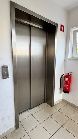 elevator in an apartment building, fire extinguisher in the entranceの写真素材