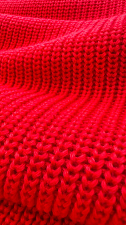 A close up of a red knit sweater.の写真素材
