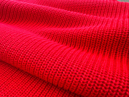 A close up of a red knit sweater.の写真素材