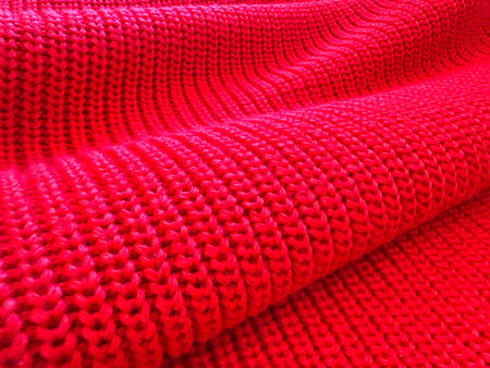 A close up of a red knit sweater.の写真素材