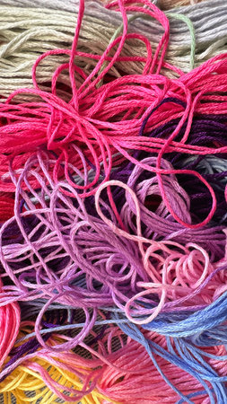 A solid background of colorful threads for cross stitch and needlework.の写真素材