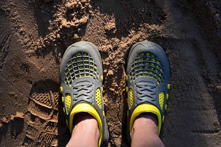 feet of a woman in special shoes for working in the garden and vegetable garden. Top view. Waterproof shoesの写真素材