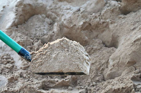 large shovel with sand. Landscape works, landscaping of the territory. Construction site