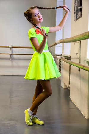 beautiful girl is standing in dance class, preparing to perform on stage. Festive moodの写真素材