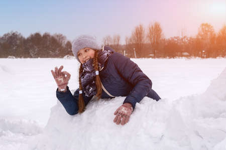 Beautiful happy girl in winter in warm clothes. Close-up. Artistically colored and tinted...