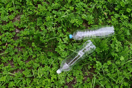Empty plastic bottles are lying on the grass. top view. Protection of nature, ecology from pollution. World Environment Day, concept of Earth Dayの写真素材