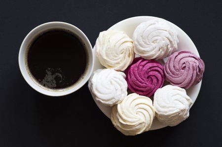 colored zephyr with a cup of coffee on black backgroundの写真素材