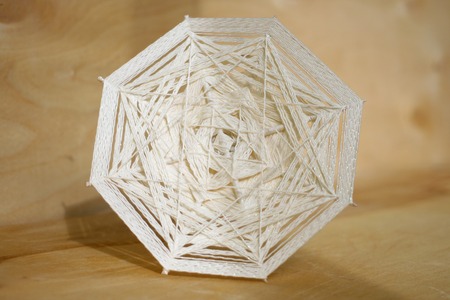 handmade white mandala on a wooden backgroundの写真素材