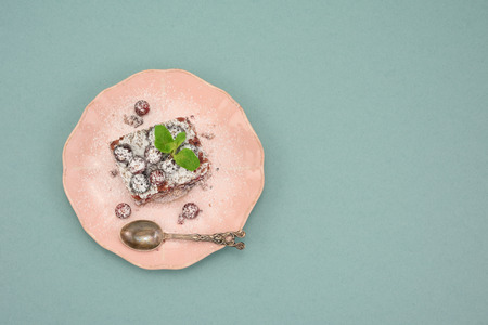 Dessert on vintage pink plate over turquoise background, copy space.の写真素材
