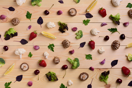 Fruts, vegetables and berries over wooden background. Variety of colorful food ingredients, healthy diet concept. Vegetarian organic nutrition. View from above.の写真素材
