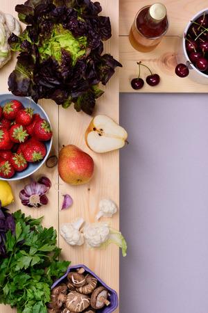 Organic food background. Fresh vegetables and fruits on wooden store shelves. Top view, copy space.の写真素材