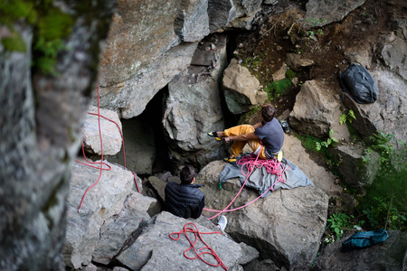 Team of climbers on the rock, pepare to climb. Climbing equipment.