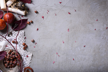 Fresh oranges with nuts over grey background. Romantic breakfast vintage style. Top view, copy space.の写真素材
