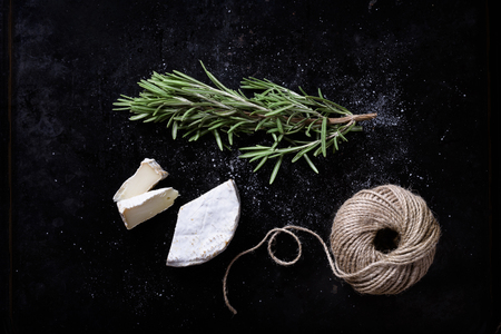 Brie cheese with fresh herbs, swiss appetizer. Top view.の写真素材