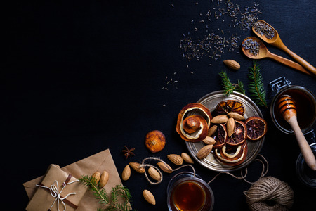 Cooking and decorating christmas drinks, dried orange slices and nuts.  New year holiday theme background. Above view, space for text.の写真素材