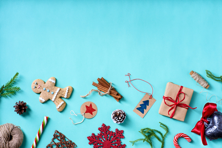Christmas homemade decorations and gingerbread cookies over turquoise table. Top view, copy space.の写真素材