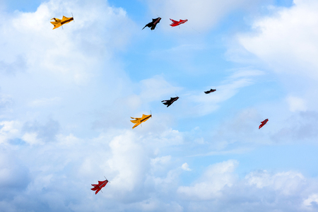 Colorful kites flying in the sky, kite festival. Background beautiful kites souring in the blue summer sky.の写真素材