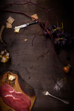 Beef steak, raw meat ingredient for cooking on kitchen counter, top view, copy space. Dinner food frame.の写真素材