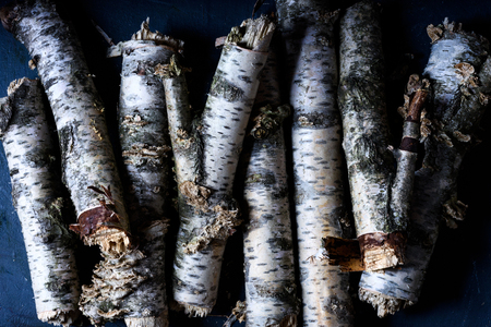 Birch logs, woodpile dry birch firewood. Scandinavian countryside style background. Flat lay, view above.の写真素材