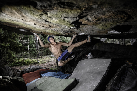 Climbing Sport. Strong, muscular athlete on beautiful rocks. Active healthy sports lifestyle sportsman outside training. Travel destination Aland Islands, Finland.の写真素材