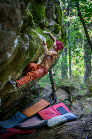 Rock climber ascending a challenging boulder. Extreme sport climbing. Freedom, risk, challenge, success. Sport and active life concept.の写真素材