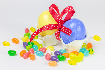 Easter eggs in little nest decorated with red ribbon and jelly belly