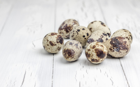 Quail eggs on the wooden table closeupの写真素材