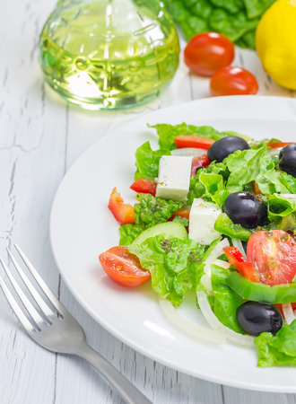 Greek salad on a white plate closeupの写真素材