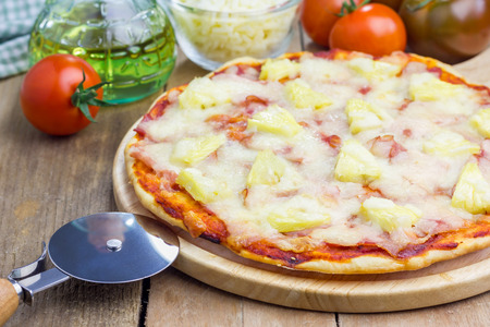 Homemade ham, bacon and pineapple Hawaii pizzaの写真素材