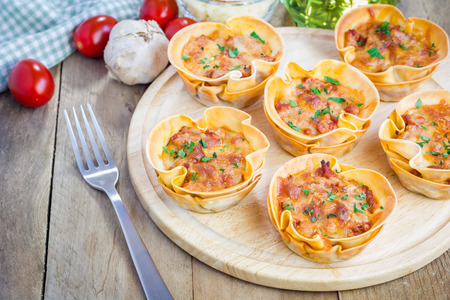 Homemade lasagna cups with minced meat, bolognese sauce topped with cheeseの写真素材