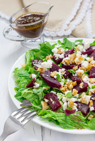 Salad with beets, feta cheese and walnuts, dressed with balsamic sauceの写真素材