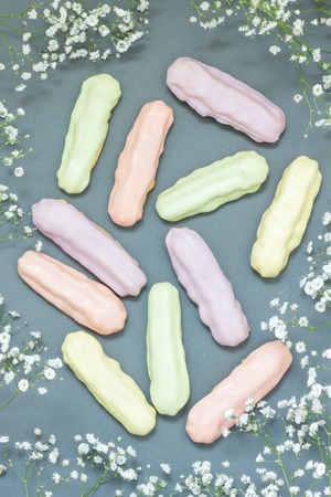 Homemade eclairs with pastel color icingの写真素材