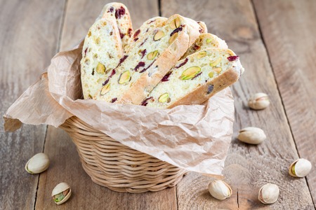 Biscotti with cranberry and pistachio in vine basketの写真素材