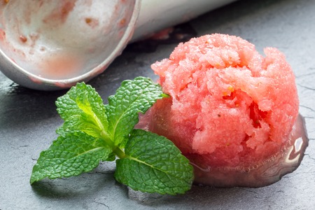 Homemade strawberry sorbet on a gray slateの写真素材