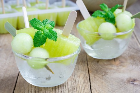 Homemade melon in the glass on a wooden tableの写真素材