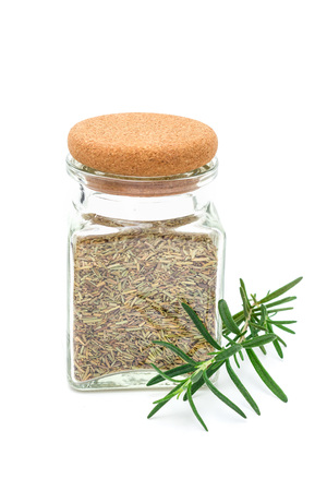 Dry rosemary tea in glass jar, isolated on whiteの写真素材