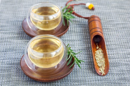 Herbal rosemary tea in a glass cup on oriental background, horizontalの写真素材