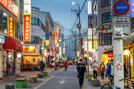 People walking in the street of the Gung-dong shopping and entertainment district at evening, Daejeon, South Korea, 12 March 2017のeditorial素材