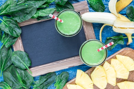 Detox green smoothie with spinach, pineapple, banana and yogurt, horizontal, top view, copy spaceの写真素材