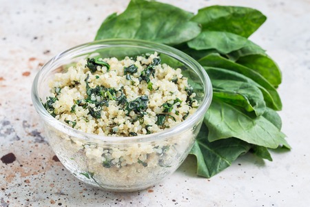 Ingredients for stuffed tomatoes or vegetarian salad with quinoa, spinach, garlic and olive oil,...