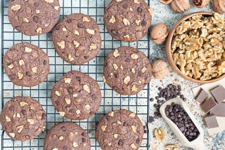 Homemade chocolate cookies with walnuts and chocolate chips on the cooling rack, horizontal, top viewの写真素材