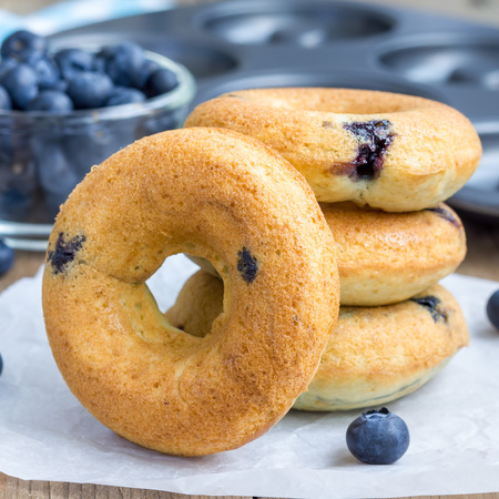 Freshly baked doughnuts with blueberries for breakfast, square formatの写真素材