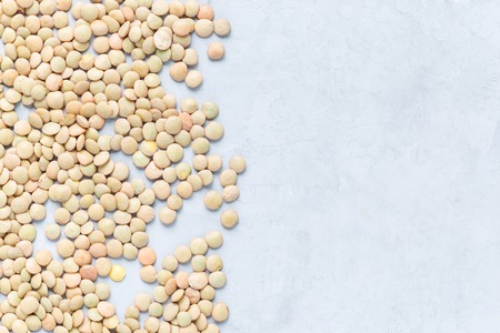 Uncooked dry green lentils on concrete background, horizontal, copy space, top viewの写真素材