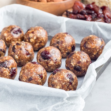 Healthy homemade energy balls with cranberries, nuts, dates and rolled oats, square formatの写真素材