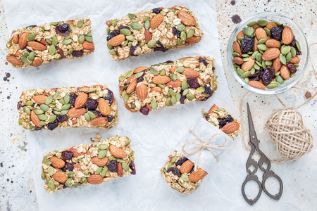 Homemade granola energy bars with figs, oatmeal, almond, dry cranberry and pumpkin seeds, healthy snack, top viewの写真素材