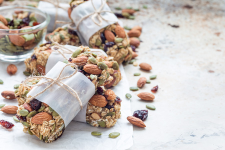 Homemade granola energy bars with figs, oatmeal, almond, dry cranberry and pumpkin seeds, healthy snack, copy spaceの写真素材