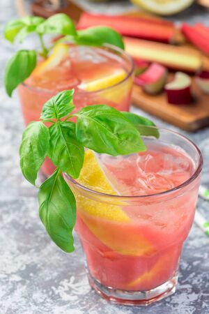 Refreshing lemonade with rhubarb, lemon, sparkling water and basil in a glass, vertical, closeupの写真素材