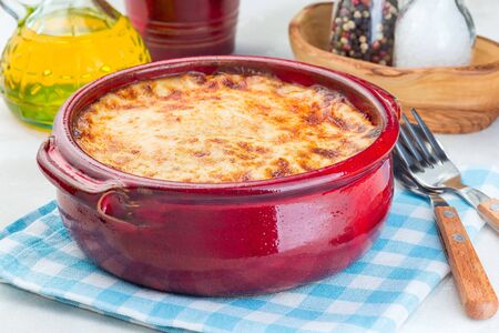 Greek dish moussaka made in a traditional ceramic pot, horizontal, closeupの写真素材