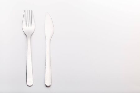 Silverware set knife and fork on a gray background, horizontal,  copy spaceの写真素材