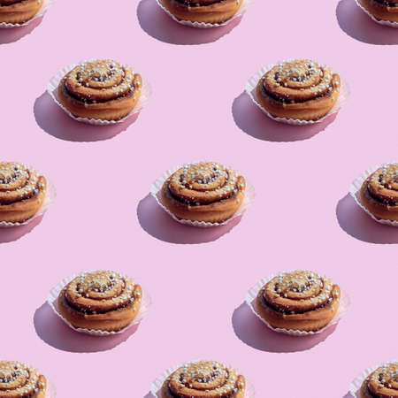 Seamless pattern with cinnamon buns on a pink background, hard shadows,  square formatの写真素材